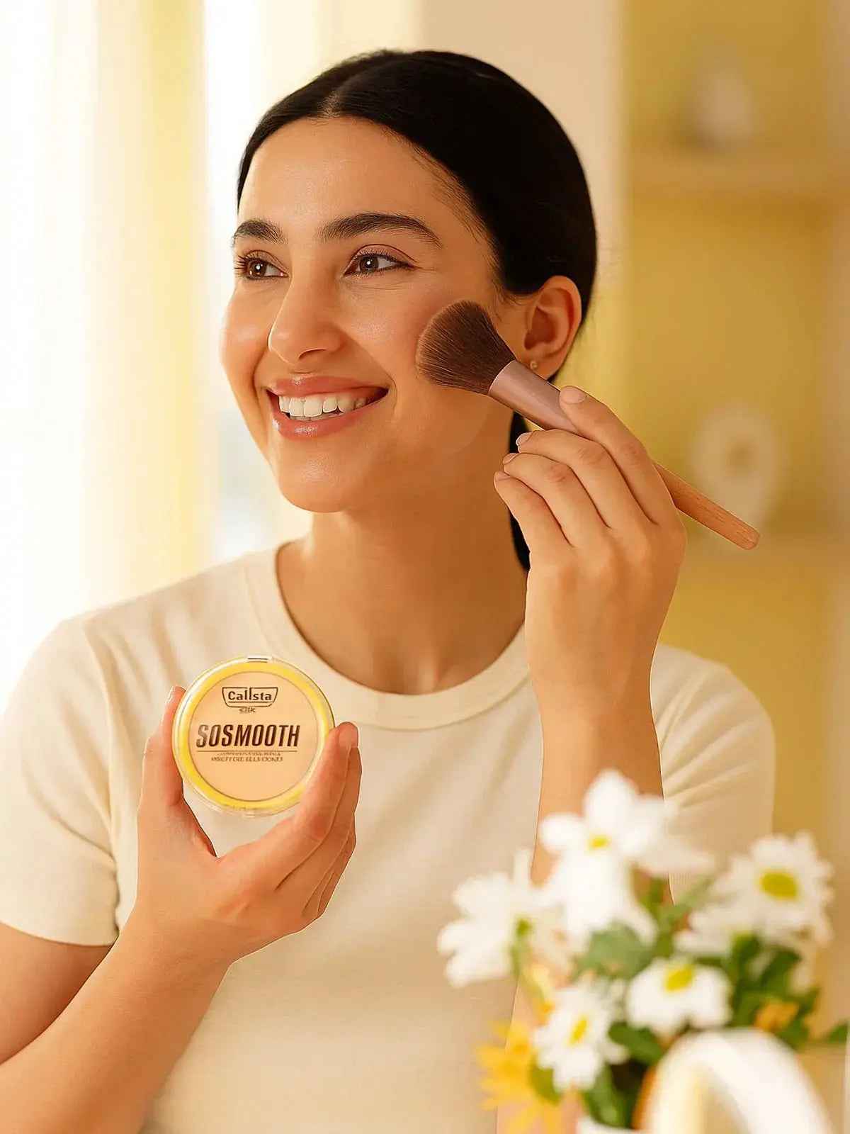 Woman applying Callista SOSMOOTH setting powder with brush for flawless makeup finish