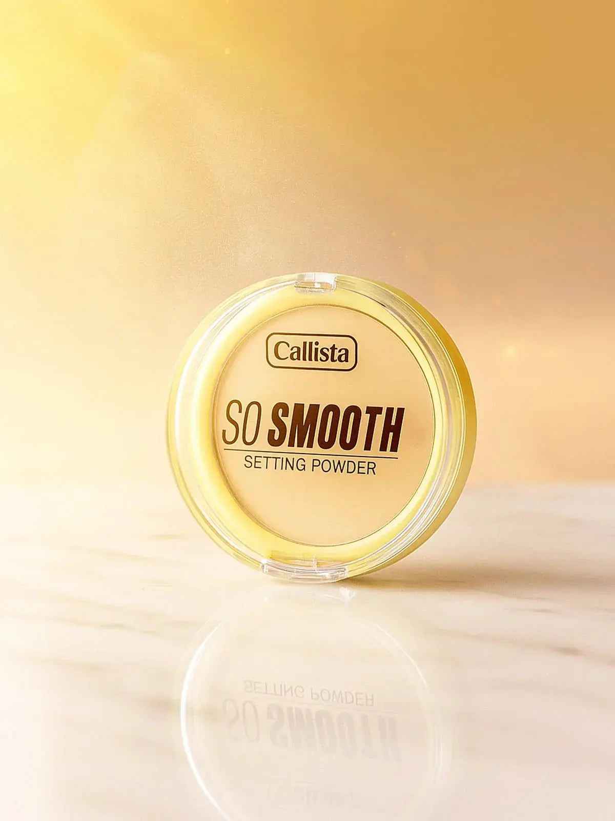 Callista So Smooth Setting Powder in clear compact on marble surface, golden glow background