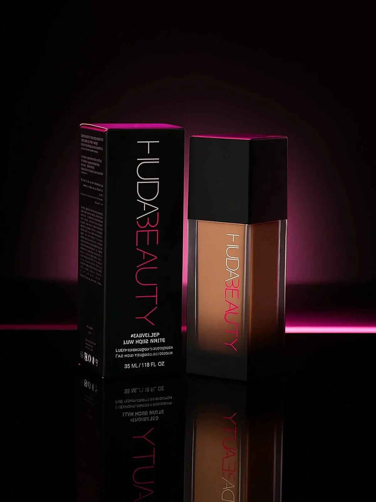 Huda Beauty foundation bottle and box with pink neon glow, luxury makeup product
