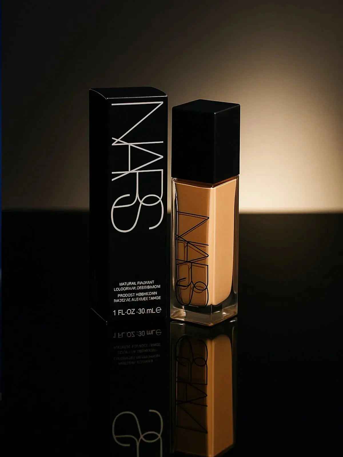 NARS Natural Radiant Longwear Foundation bottle and box, sleek black packaging, warm glow lighting