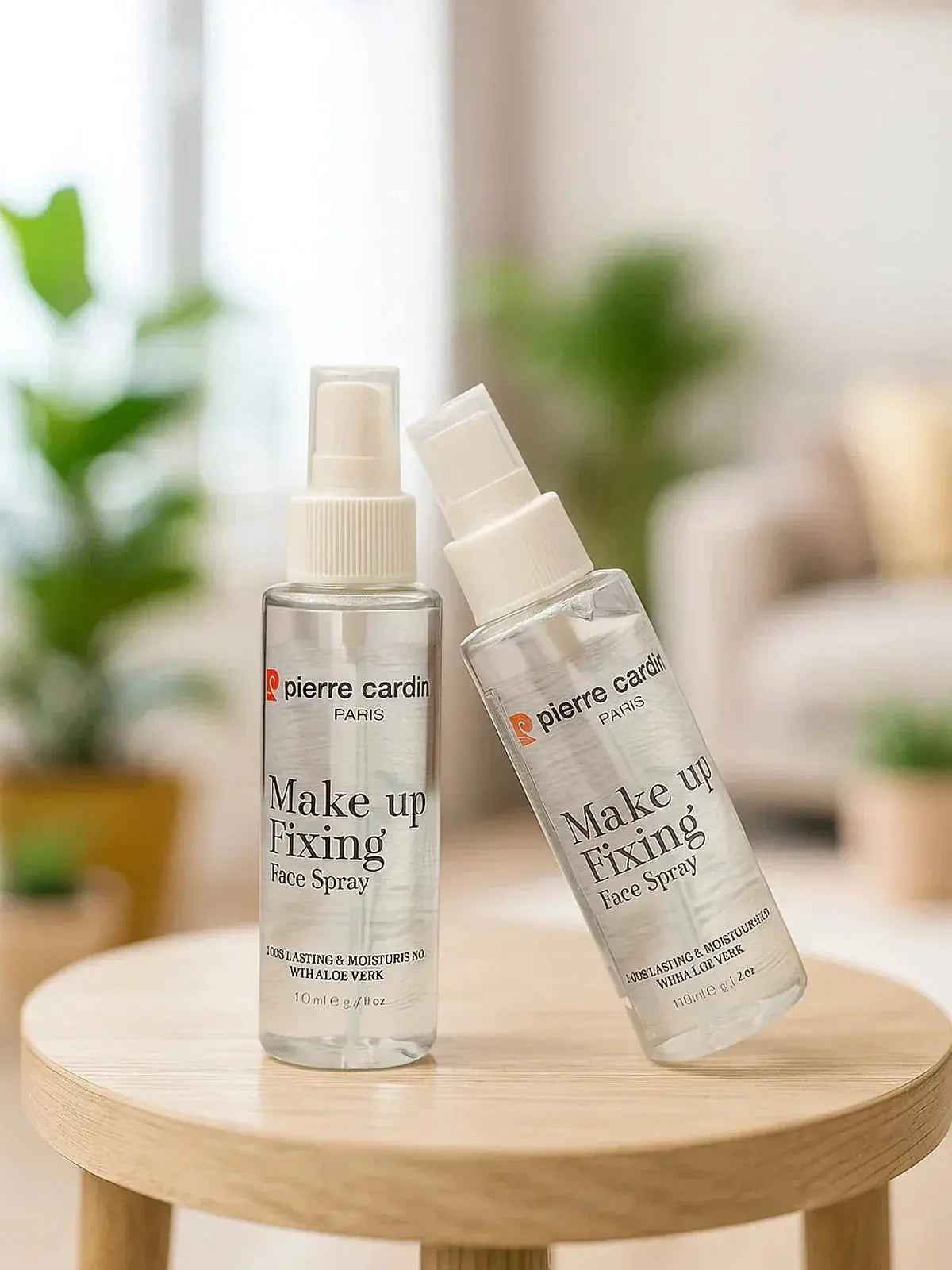 Pierre Cardin Make Up Fixing Face Spray with aloe vera, 110ml bottle on wooden table, ideal for lasting makeup