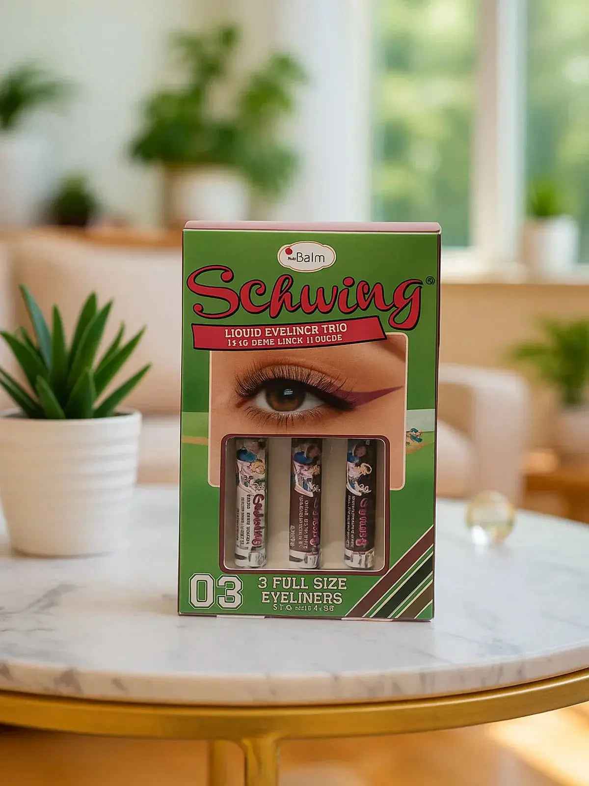 Schwing Liquid Eyeliner Trio set with 3 full-size waterproof eyeliners in vibrant colors, displayed on marble table