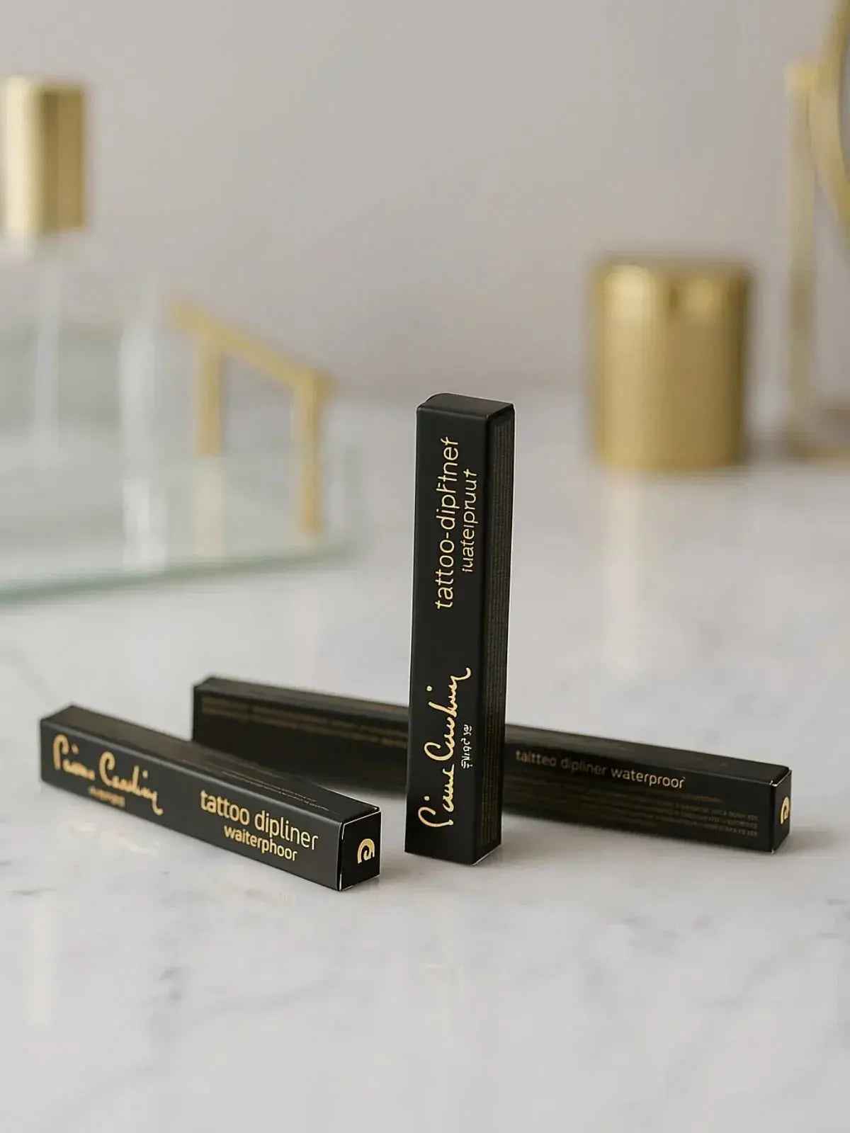Waterproof tattoo eyeliner in sleek black packaging on marble surface, luxury makeup essential