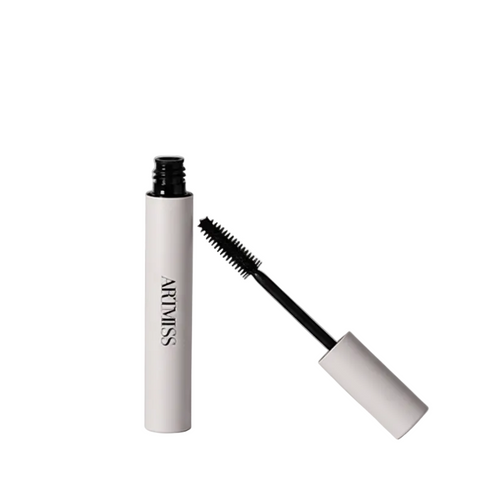 Mascara with white casing and black wand on a white background