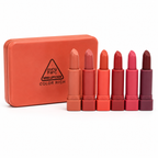 Set of mini lipsticks in various shades with an orange case on a white background