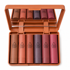 Set of lipsticks in a brown case with visible brand logo.